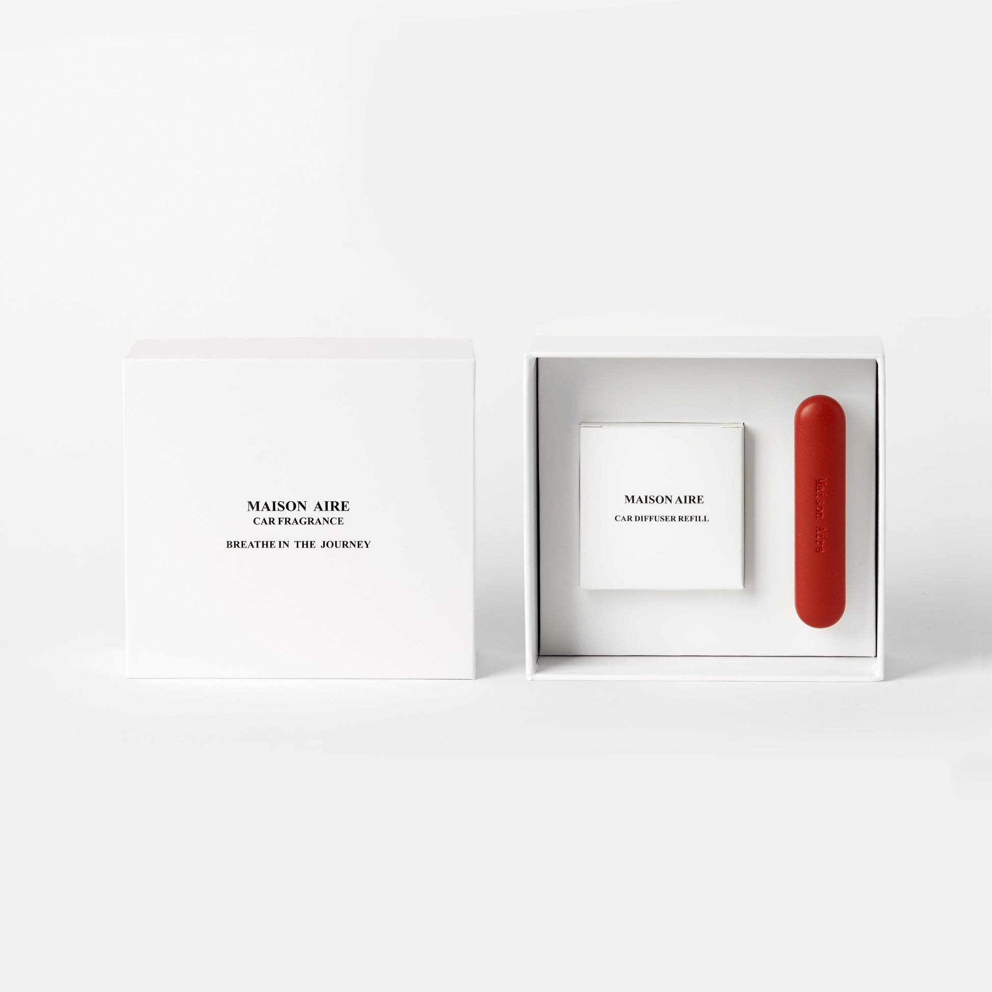 Maison Aire car fragrance gift pack set with a white box scents refill pack labeled Breathe in the Journey and a red car diffuser with refill inside