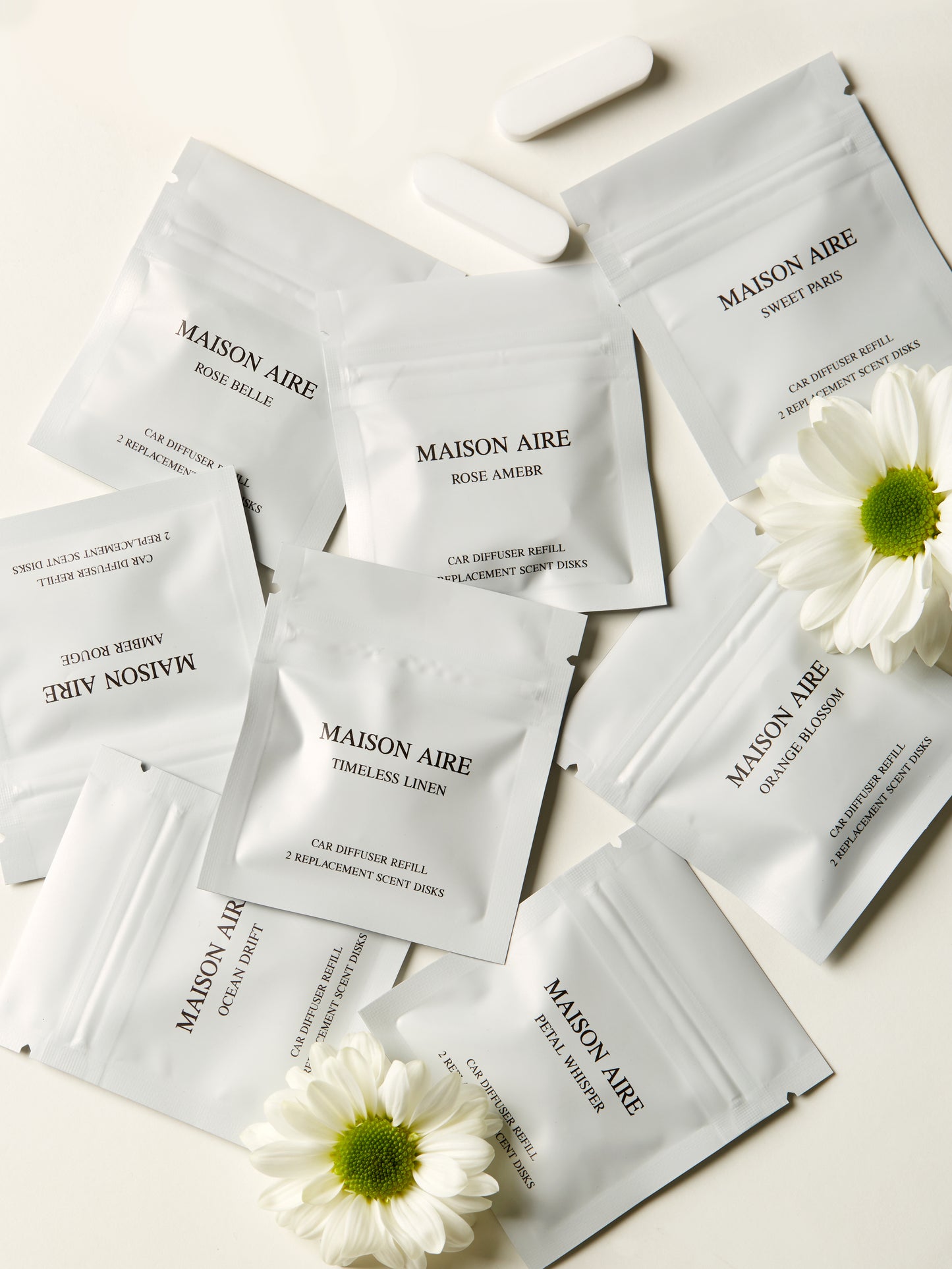 MAISON AIRE car freshener refill scent packets with white flowers on light background